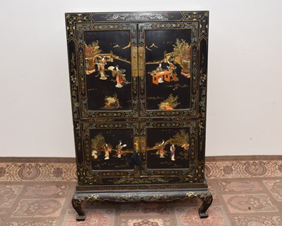 Lot 136 - A late 19th or early 20th century Japanese black lacquer and inlaid cabinet on stand