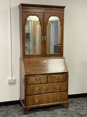 Lot 140 - A Georgian walnut bureau elevated bookcase