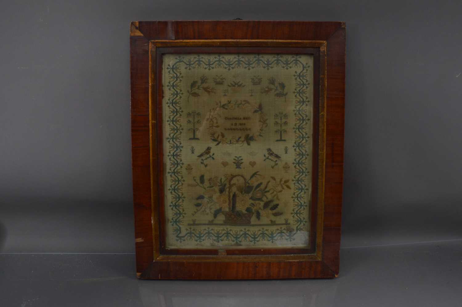 Lot 300 - A characterful 19th Century sampler depicting birds and a basket of flowers