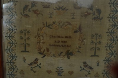 Lot 300 - A characterful 19th Century sampler depicting birds and a basket of flowers