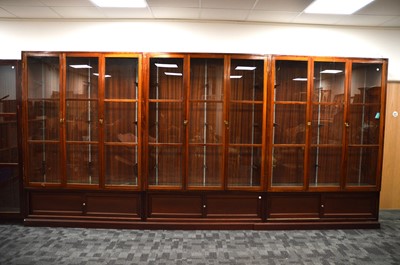 Lot 559 - A set of three triple 20th century hard wood glaze shop display cabinets