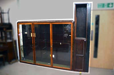 Lot 561 - An Edwardian pine and stained wood triple satinwood glazed shop display cabinet
