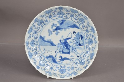 Lot 378 - A Chinese blue and white scalloped dish decorated with a 'Love Chase' hunting scene