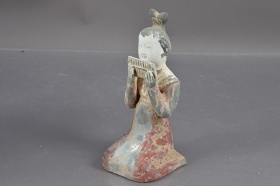 Lot 381 - A Chinese Tang Dynasty style polychrome painted terracotta figure of a kneeling court musician