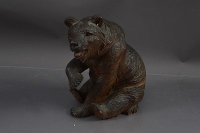 Lot 402 - A Blackforest carved oak figuring of a seated bear