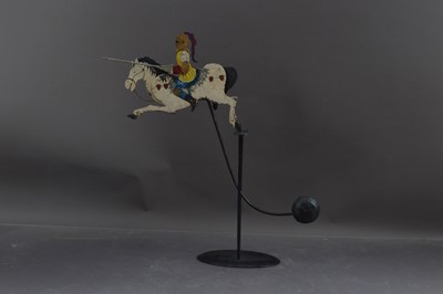 Lot 430 - A metalwork pendulum toy or balance figure of a jousting knight on horseback