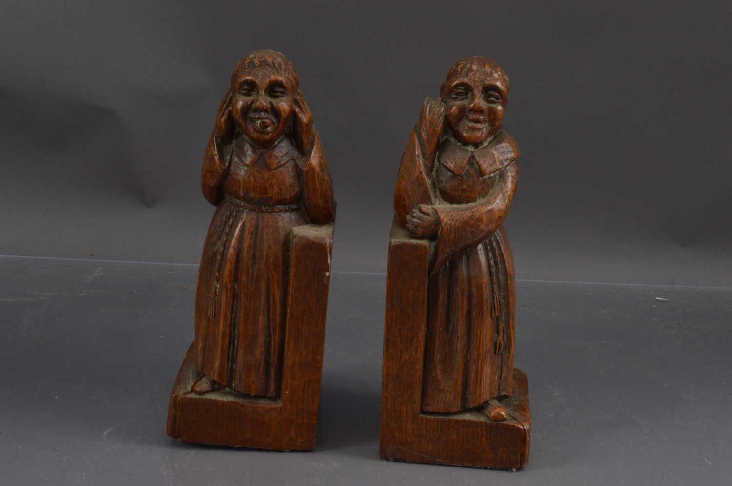 Lot 432 - A humorous pair of mischievous monk carved oak bookends
