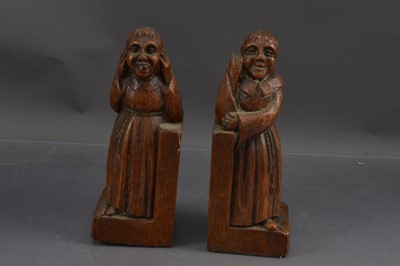 Lot 432 - A humorous pair of mischievous monk carved oak bookends