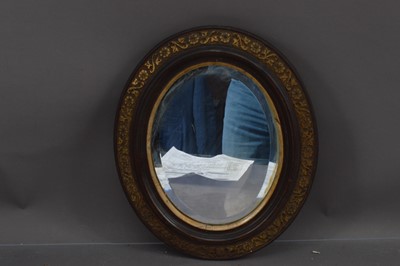 Lot 434 - A Victorian oval wall mirror with a bevelled glass plate