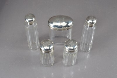 Lot 484 - A group of Five late 19th Century silver topped glass dressing table bottles