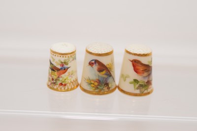 Lot 565 - Two Royal Worcester porcelain thimbles and another