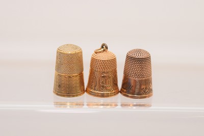 Lot 568 - Three yellow metal thimbles