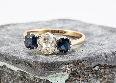 Lot 29 - A three stone 18ct gold and platinum diamond and sapphire ring