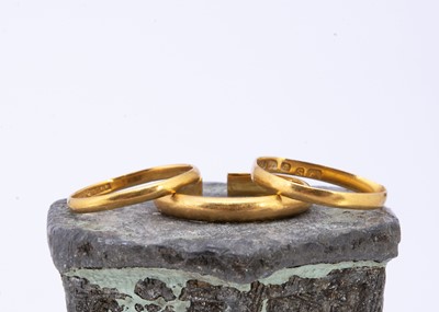 Lot 83 - Three 22ct gold misshapen wedding bands