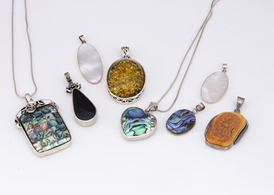 Lot 87 - A collection of silver and organic gem framed pendants