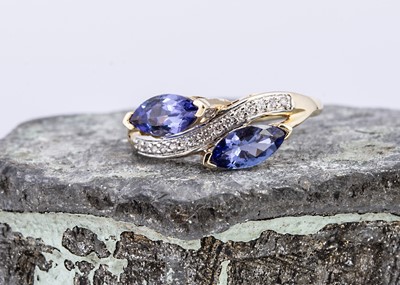 Lot 96 - A yellow 9ct gold tanzanite and zircon crossover dress ring