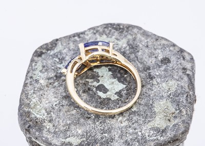 Lot 96 - A yellow 9ct gold tanzanite and zircon crossover dress ring