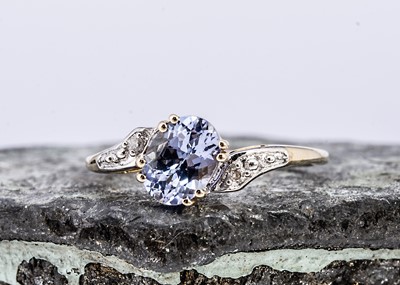 Lot 98 - A tanzanite and diamond crossover style 9ct gold dress ring