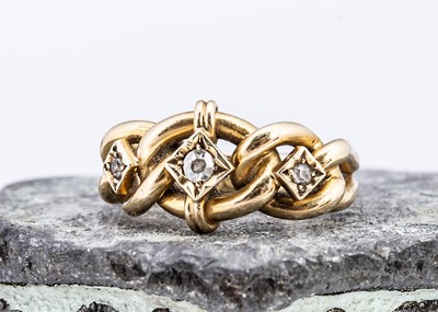 Lot 101 - An 18ct gold diamond set knot dress ring