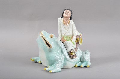 Lot 135 - A 20th century Japanese Kutani porcelain figurine of a man seated on a frog