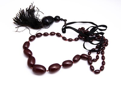 Lot 128 - A large string of graduated 'cherry amber' beads