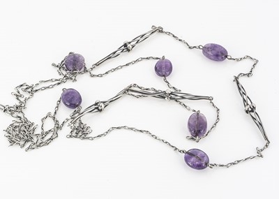 Lot 79 - An Arts and Crafts amethyst pebble and silver guard chain