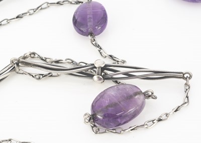 Lot 79 - An Arts and Crafts amethyst pebble and silver guard chain