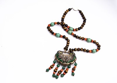 Lot 138 - An early 20th Century Chinese white metal, enamel and gem set pendant and chain