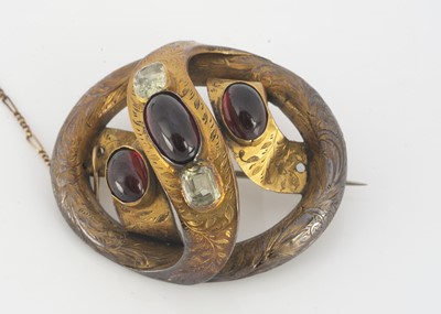Lot 81 - A Victorian yellow metal garnet and beryl set knot brooch