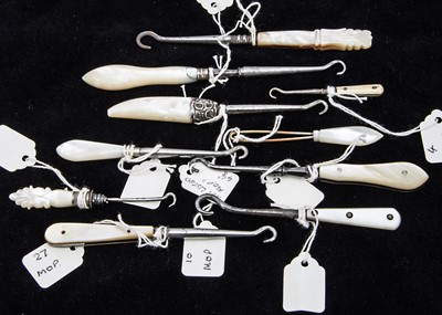 Lot 203 - Nine small Victorian and later mother of pearl handled button hooks and one very small bone handled example