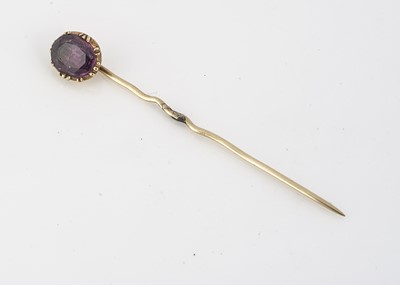 Lot 85 - A ruby and gold set stick pin