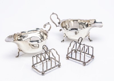 Lot 219 - Two silver sauce boats and small toast racks