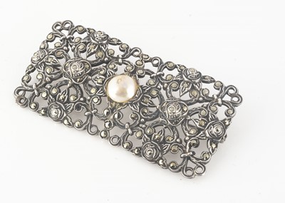 Lot 95 - An Art Deco marcasite, silver and simulated panel brooch