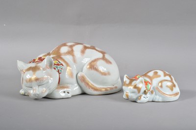 Lot 136 - A late Meiji period Japanese Kutani porcelain recumbent cat