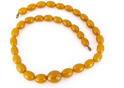 Lot 332 - A string of graduated pressed amber oval beads