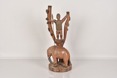 Lot 304 - A carved African figure of a Hunter and an Elephant