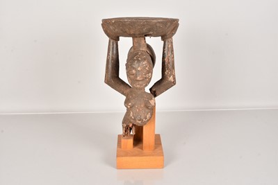 Lot 306 - A carved African stool