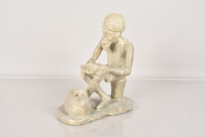 Lot 311 - A carved soapstone figure of an African Gentleman playing the Kalimba