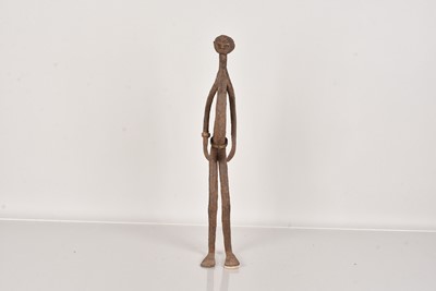 Lot 315 - An elongated metal figure of a male