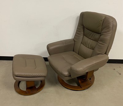 Lot 2 - A modern leather reclining armchair and footstool