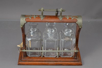 Lot 103 - An early 20th century oak and silver plated (now dulled) cut glass tanalus