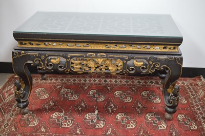 Lot 182 - A Chinese style black lacquer and gilt wood coffee table