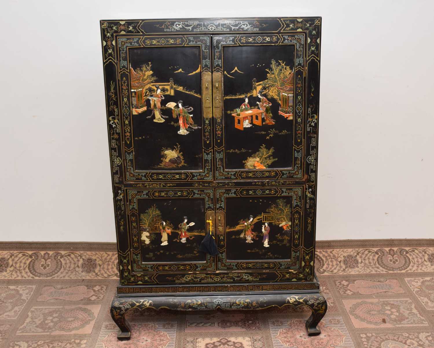 449 - A late 19th century or early 20th century Japanese black lacquer and inlaid cabinet on stand,