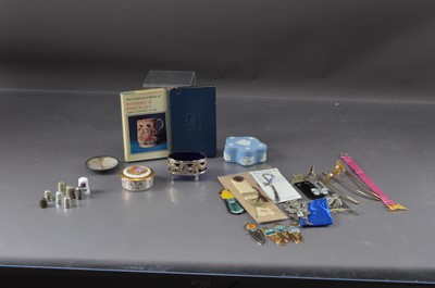 Lot 455 - A selection of bookmark and thimbles, including examples in metal and porcelain together with two trinket boxes and a blue glass lined salt.