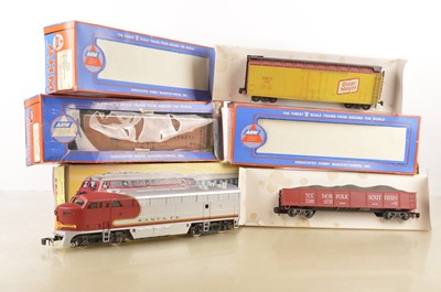 Lot 850 - A Rivarossi 0 Gauge Santa Fe Diesel Locomotive and three 'for AHM' Wagons (4)