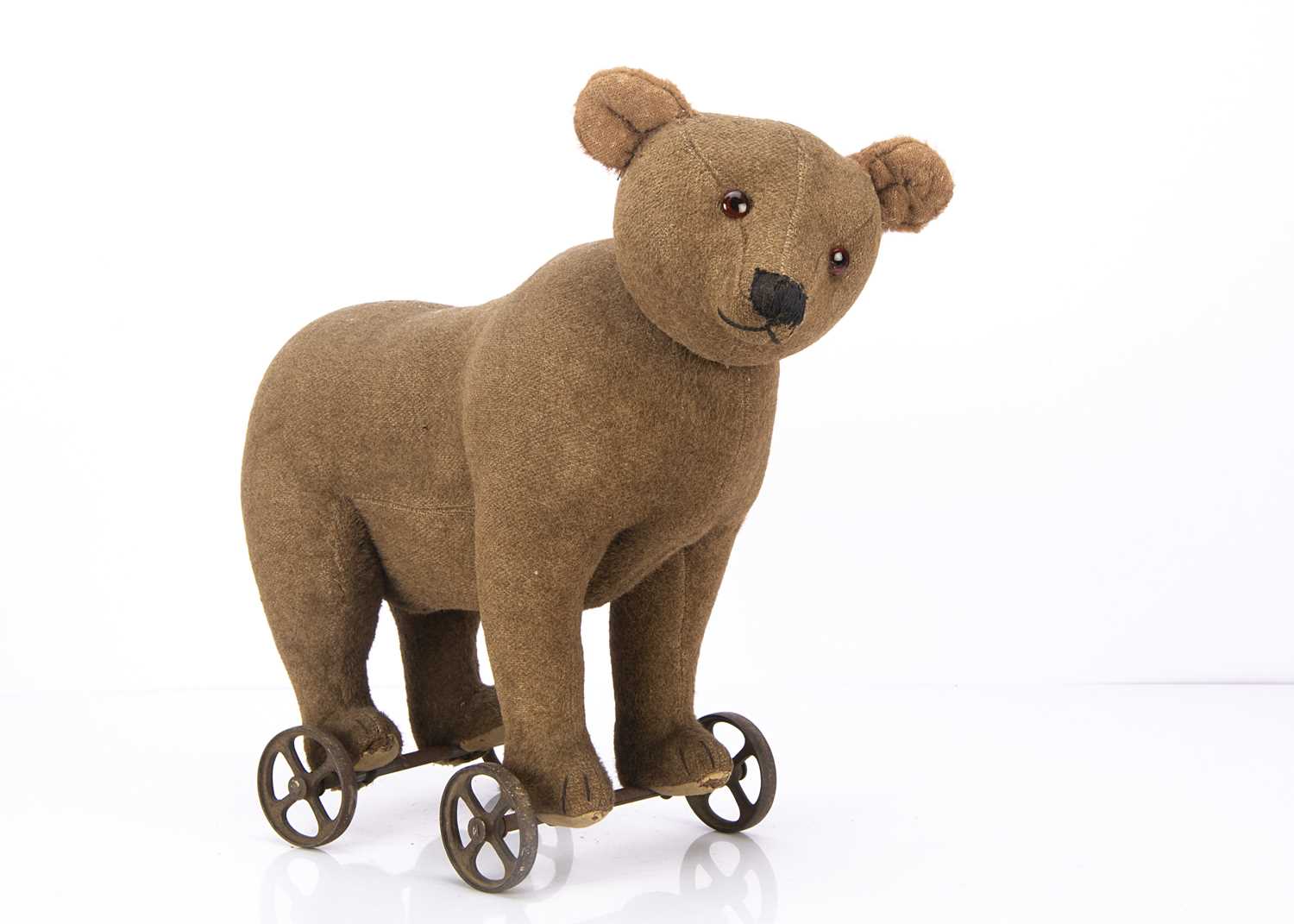 91 - An early Steiff centre-seam bear on wheels 1905-10,