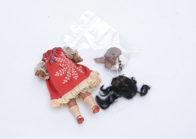 Lot 144 - A German bisque headed black dolls' house doll