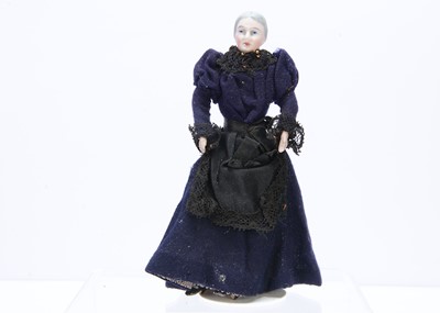 Lot 371 - An Edwardian bisque shoulder-head dolls' house elder lady doll