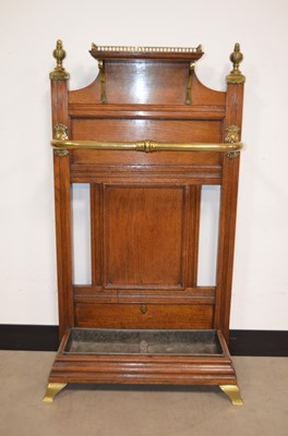 Lot 49 - A late Victorian oak and brass hall umbrella or stick-stand by James Shoolbred & Co