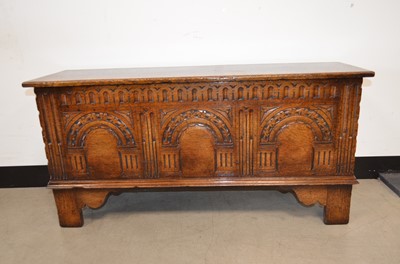 Lot 56 - A reproduction carved oak chest or coffer of neat proportions